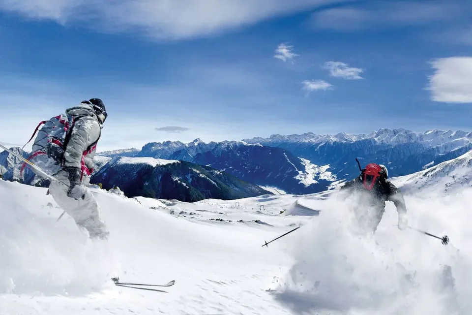 Skifahrer am Thurntaler mit Blick auf die verschneiten Berge